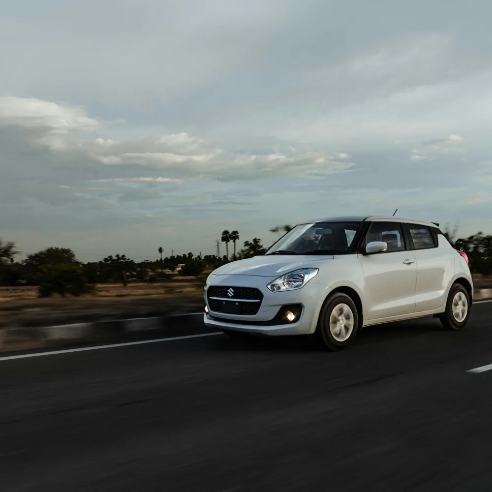 Car travelling on an open highway at dusk