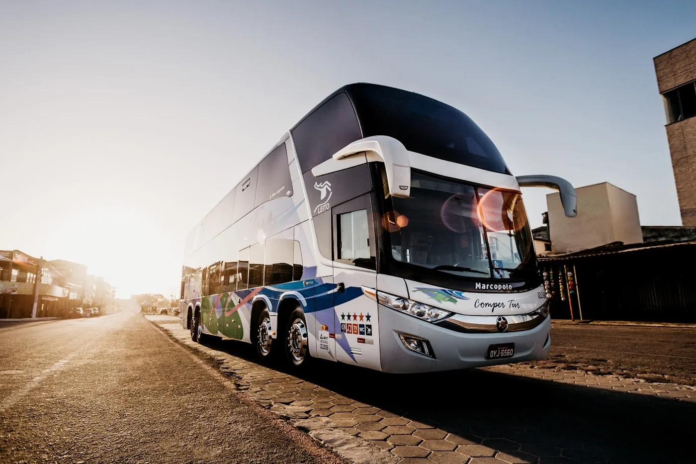 Air-conditioned coach from the Sayali TransLink fleet on the highway at sunrise