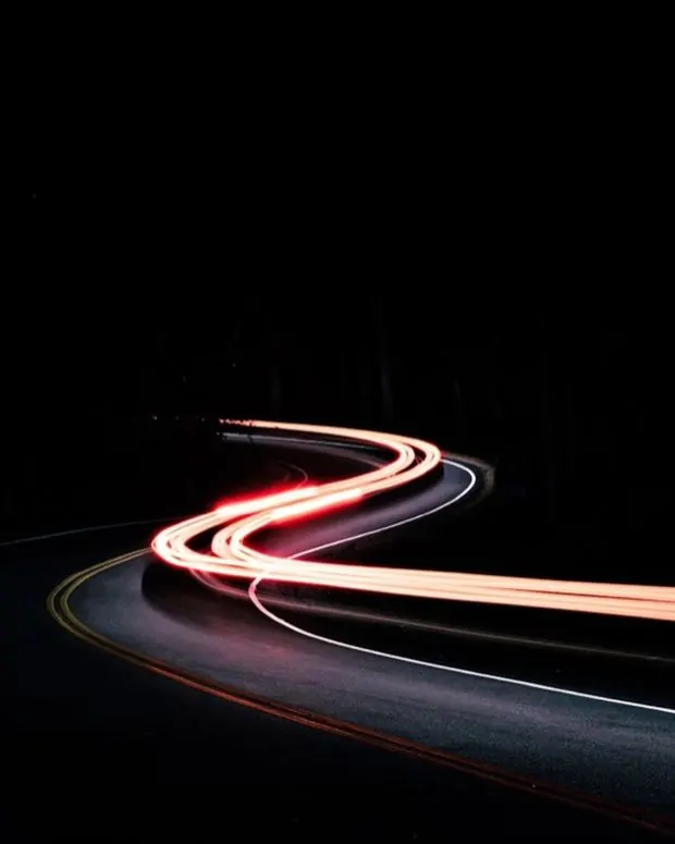 Vehicle light trails on a highway at night