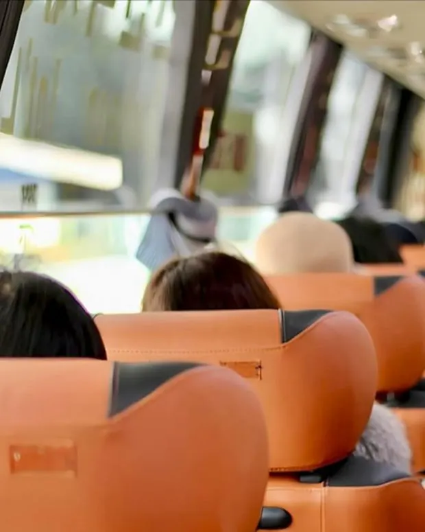 Employees seated in an air-conditioned coach
