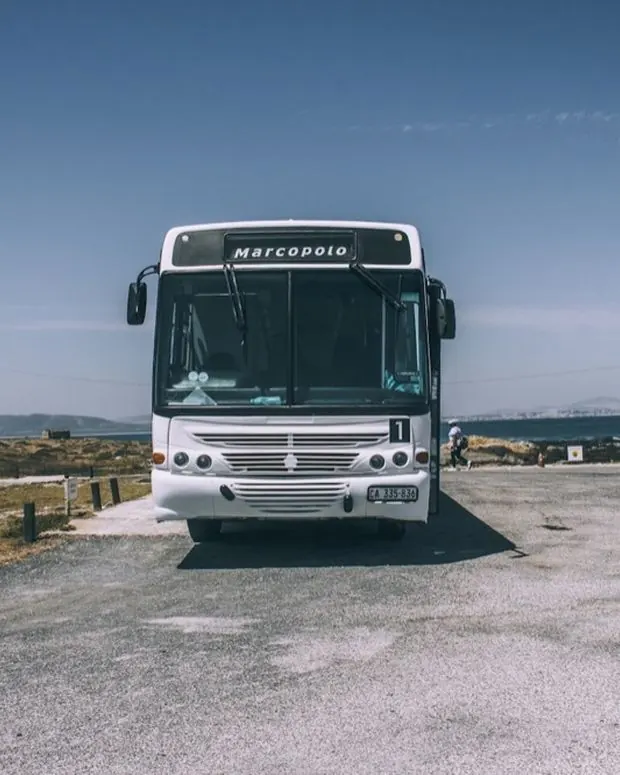 A full-size air-conditioned coach on open tarmac